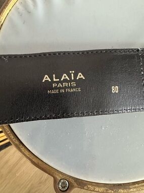Alaïa Black Leather Belt with Gold Stamping